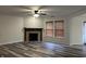 Spacious living room with fireplace, modern floors, and natural light at 10622 Howe Rd, Fishers, IN 46038