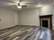 Open-concept living room with modern floors and fireplace at 10622 Howe Rd, Fishers, IN 46038