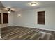 Open living area featuring wood-look floors and modern lighting at 10622 Howe Rd, Fishers, IN 46038
