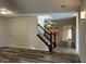 Open-concept living area with modern flooring and decorative staircase at 10622 Howe Rd, Fishers, IN 46038