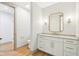 Bathroom with white vanity, decorative mirror and sconces at 10756 Dartmoor Way, Zionsville, IN 46077