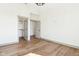 Empty bedroom with wood floor and view of closet and bathroom doorways at 10756 Dartmoor Way, Zionsville, IN 46077