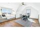 Cozy bonus room with pitched ceiling, bright windows, and dining and lounge areas at 10756 Dartmoor Way, Zionsville, IN 46077