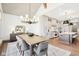 Dining room adjacent to kitchen featuring modern chandelier and large table with seating for eight at 10756 Dartmoor Way, Zionsville, IN 46077