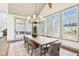 Dining room with natural light, a view of the porch, and a large table perfect for entertaining guests at 10756 Dartmoor Way, Zionsville, IN 46077