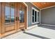 Charming front porch featuring a wood door and a brick foundation at 10756 Dartmoor Way, Zionsville, IN 46077