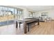 Spacious game room with sliding doors to outside, hardwood floors and a pool table at 10756 Dartmoor Way, Zionsville, IN 46077