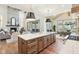 Kitchen island with quartz countertops and brass pendants providing a focal point between dining and living areas at 10756 Dartmoor Way, Zionsville, IN 46077