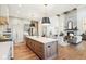 Gourmet kitchen island with sink, hardwood floors, and open to the living area; perfect for entertaining guests at 10756 Dartmoor Way, Zionsville, IN 46077