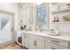 Bright kitchenette features custom cabinetry, stone countertops and stainless steel appliances at 10756 Dartmoor Way, Zionsville, IN 46077