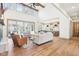 Bright, open living room featuring a fireplace, high ceilings, and large windows overlooking the backyard at 10756 Dartmoor Way, Zionsville, IN 46077