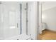 Bright glass-enclosed shower with white and blue tiled accents at 10756 Dartmoor Way, Zionsville, IN 46077