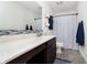 Bathroom featuring a large mirror, vanity, and a shower with blue accents at 1142 Cobra Dr, Franklin, IN 46131