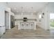 Bright kitchen with white cabinets, island with seating, and stainless steel appliances at 1142 Cobra Dr, Franklin, IN 46131