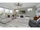 Modern living room with fireplace, mounted TV, and lots of natural light from large windows at 1142 Cobra Dr, Franklin, IN 46131