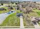 Inviting two-story home with a spacious yard, long driveway, and a serene pond at 12121 N Berling Dr, Mooresville, IN 46158