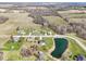 A residential street featuring two-story homes, a serene pond, and mature trees at 12121 N Berling Dr, Mooresville, IN 46158