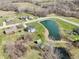 Two-story home with nearby pond, lush greenery, and surrounding mature trees at 12121 N Berling Dr, Mooresville, IN 46158