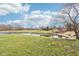 Expansive backyard featuring a pond, lush greenery, and distant views of the home's exterior at 12121 N Berling Dr, Mooresville, IN 46158