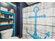 Bathroom with dark blue walls, anchor decor, a blue shelving unit, and a shower with an anchor curtain at 12121 N Berling Dr, Mooresville, IN 46158