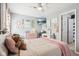 Cozy bedroom with light-colored walls, decorative items, a ceiling fan, a television, and comfortable furnishings at 12121 N Berling Dr, Mooresville, IN 46158
