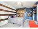 Stylish bedroom with a sliding barn door and sports-themed decor, offering a unique design at 12121 N Berling Dr, Mooresville, IN 46158