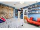 Well-lit bedroom featuring a sliding barn door with blue paint, plus sports-themed decor and storage at 12121 N Berling Dr, Mooresville, IN 46158