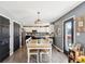 Dining room with a large table, black accent doors, and modern lighting creating a welcoming atmosphere at 12121 N Berling Dr, Mooresville, IN 46158