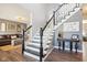 Inviting foyer features hardwood floors, staircase with black and white risers, and a decorated accent table at 12121 N Berling Dr, Mooresville, IN 46158