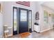 Light and bright entryway with black front door, modern decor, and wood-look floors at 12121 N Berling Dr, Mooresville, IN 46158