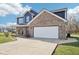 Charming two-story home features a brick and blue exterior, and a spacious two-car garage at 12121 N Berling Dr, Mooresville, IN 46158