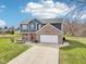 Beautiful two-story home with a blend of brick and siding, a porch, and long driveway at 12121 N Berling Dr, Mooresville, IN 46158