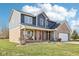 Charming two-story home features a brick and blue exterior, spacious front yard, and covered front porch at 12121 N Berling Dr, Mooresville, IN 46158