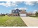 Charming two-story home features a brick and blue exterior, spacious front yard, and covered front porch at 12121 N Berling Dr, Mooresville, IN 46158
