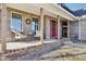 Charming brick front porch with wooden columns and cozy seating area at 12121 N Berling Dr, Mooresville, IN 46158