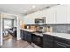 Kitchen with stainless steel appliances, white cabinets, and wood floors at 12121 N Berling Dr, Mooresville, IN 46158