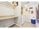 Bright laundry room featuring a folding counter, modern appliances, and ample storage at 12121 N Berling Dr, Mooresville, IN 46158