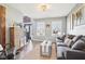 Bright living room features hardwood floors, a comfortable couch, and natural light from the windows at 12121 N Berling Dr, Mooresville, IN 46158
