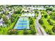 Aerial view of well-maintained tennis courts and lush landscaping in this desirable community at 12307 Pebblepointe Pass, Carmel, IN 46033