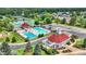 Aerial view of the community pool, clubhouse, and surrounding lush landscaping in this desirable neighborhood at 12307 Pebblepointe Pass, Carmel, IN 46033