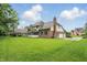 Expansive backyard featuring a screened porch, patio, and lush lawn, ideal for outdoor entertaining at 12307 Pebblepointe Pass, Carmel, IN 46033