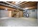 Unfinished basement with concrete floor, exposed wooden beams, and visible mechanical systems at 12307 Pebblepointe Pass, Carmel, IN 46033