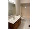 Bathroom featuring a combination shower and bathtub, single sink vanity, and white tiled flooring at 12307 Pebblepointe Pass, Carmel, IN 46033