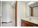 Clean, bright bathroom featuring white tiles, shower-tub combo, wood vanity, and large mirror at 12307 Pebblepointe Pass, Carmel, IN 46033
