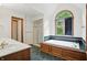 Bright bathroom features a soaking tub below a large window, and tiled shower with a glass door at 12307 Pebblepointe Pass, Carmel, IN 46033