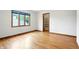 Bright bedroom features hardwood floors, closet with shelving, and large window at 12307 Pebblepointe Pass, Carmel, IN 46033