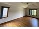 Large bedroom has hardwood floors, two windows, and neutral walls at 12307 Pebblepointe Pass, Carmel, IN 46033
