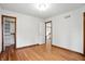 Spacious bedroom with hardwood floors, closet with shelving, and white trim at 12307 Pebblepointe Pass, Carmel, IN 46033