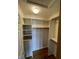 Spacious walk-in closet with built-in shelving and hardwood floors offers ample storage space at 12307 Pebblepointe Pass, Carmel, IN 46033