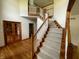 Welcoming foyer with staircase, wood floors, with natural light at 12307 Pebblepointe Pass, Carmel, IN 46033